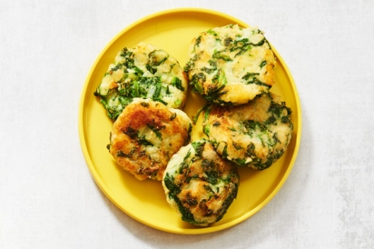 Yellow plate of four Potato and Mustard Greens Fritters