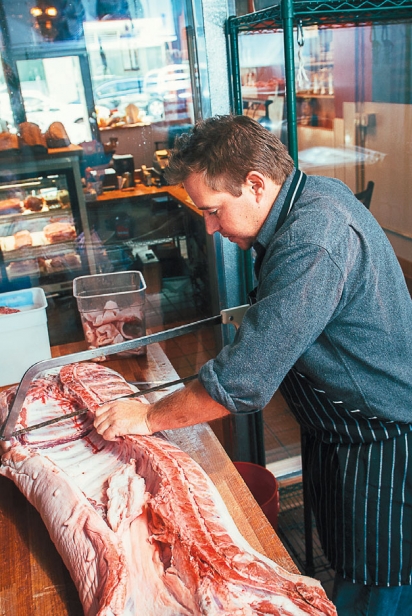 pork being cut at local butcher shop 